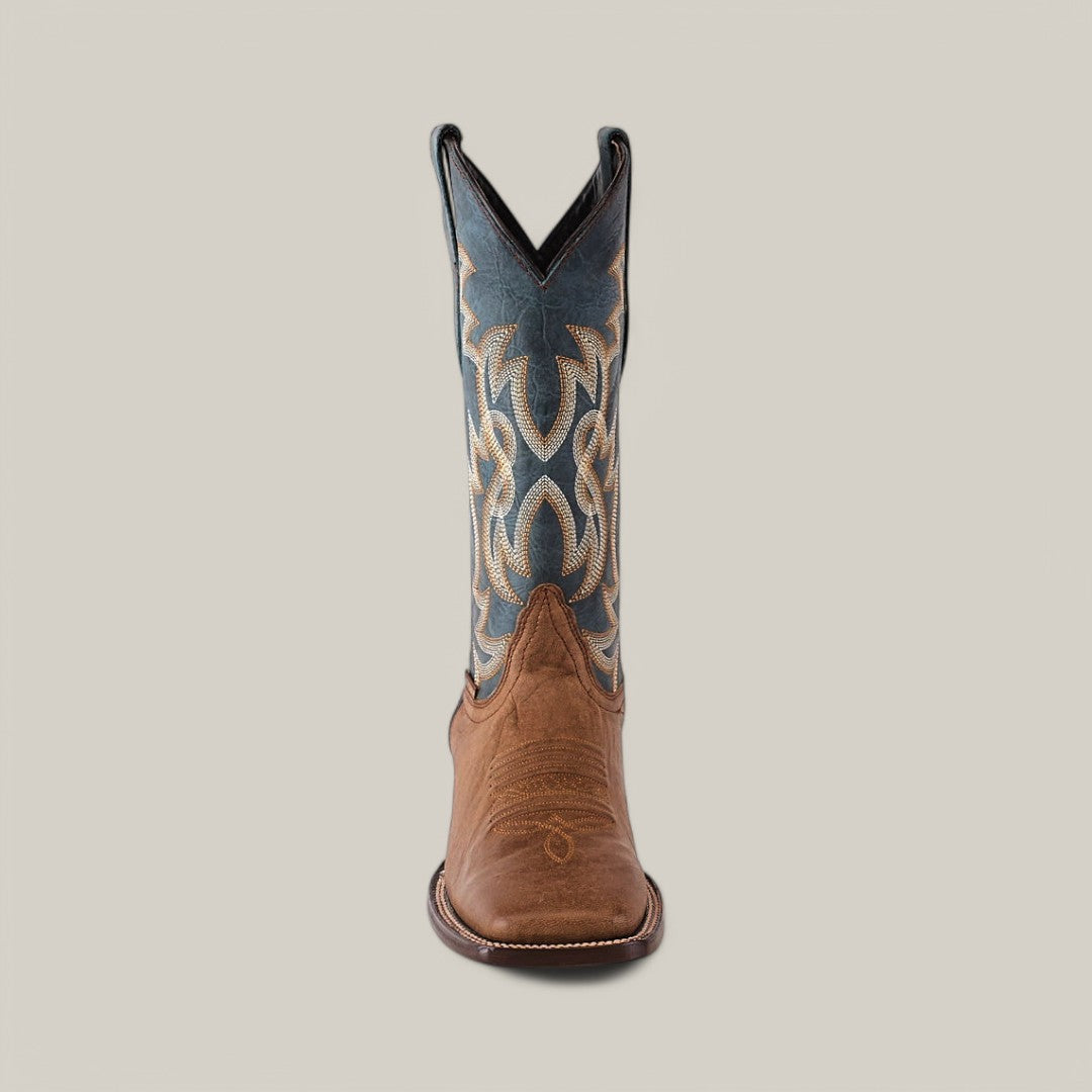 A Sierra Cinnamon - Square Toe boot highlights premium craftsmanship with a brown leather foot and intricate blue and beige stitching on the tall shaft, set against a plain, light background.