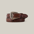 The Caiman Print Brown Belt - Texas Buckle - Kids is coiled neatly on a light gray background, showcasing its crocodile texture and ornate Texas buckle.