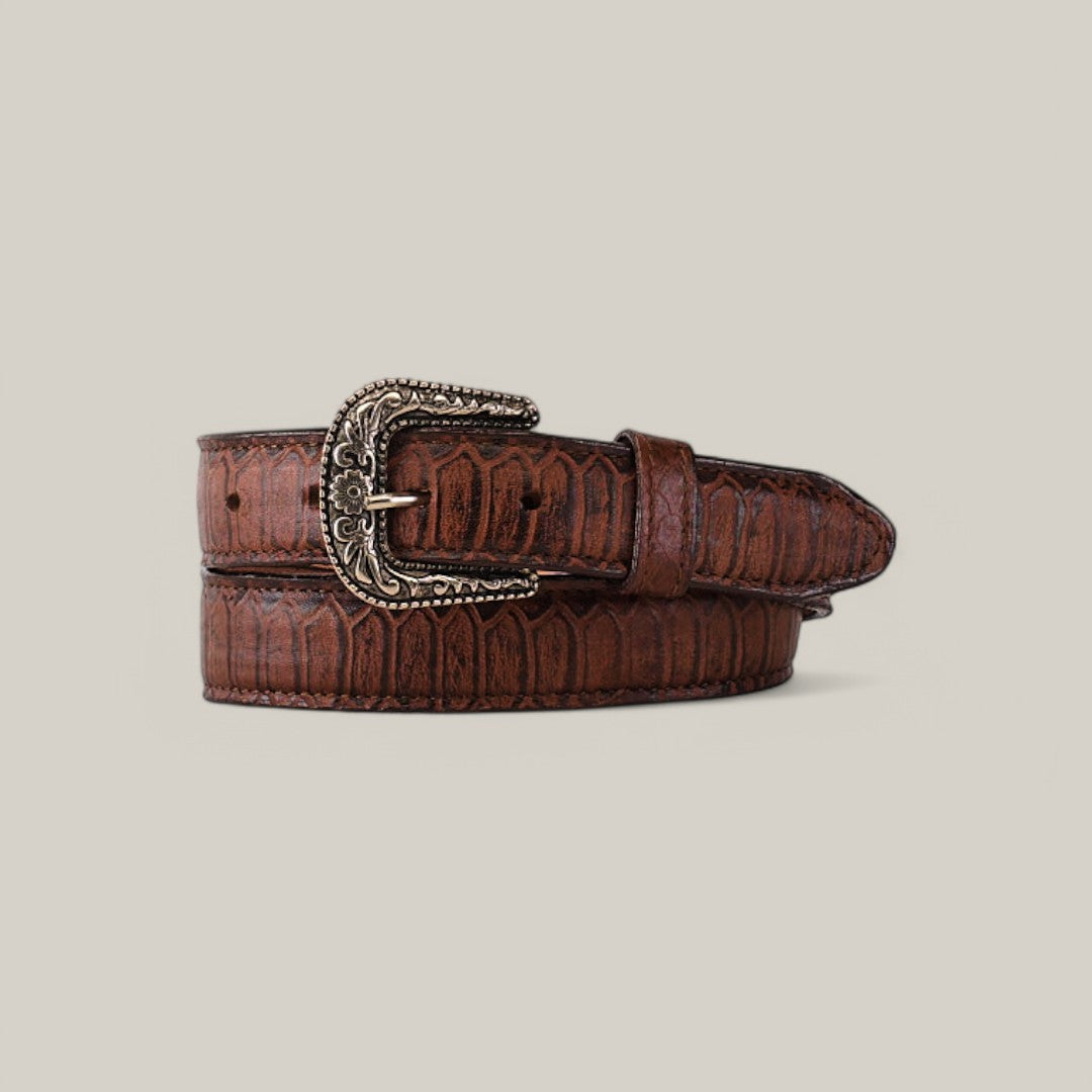 The Python Print Brown Belt - Texas Buckle - Kids, featuring an embossed reptile pattern and ornate silver buckle, is showcased rolled-up on a plain beige background.