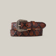 The Pirarucu Print Brown Belt for kids, featuring a Texas Buckle, is crafted from high-quality materials with a textured diamond pattern on a neutral backdrop.