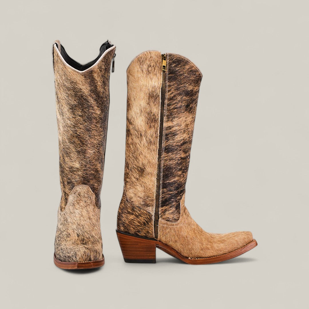 The Cowhair Pinto - Mid Shaft - Snip Toe boots feature tall brown and tan cowhide leather, a snip (pointed) toe, side zipper, and stacked wooden heels, displayed against a plain light gray background.