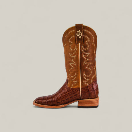 The Exotic Caiman Belly Tail - Brandy - Square Toe boot features a brown textured caiman belly leather lower, smooth stitched upper shaft with a small logo, stacked heel, square toe, and light tan sole.