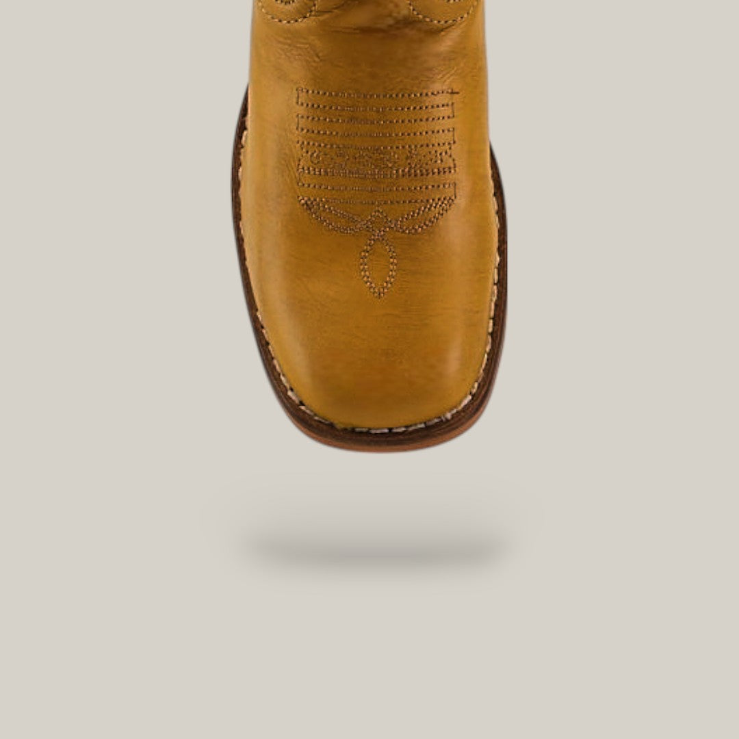The Orion Yellow - Square Toe - Kids Boots feature a yellow-brown color, detailed stitching on the square toe, and a thick sole with dark edging, photographed from above against a plain light background.