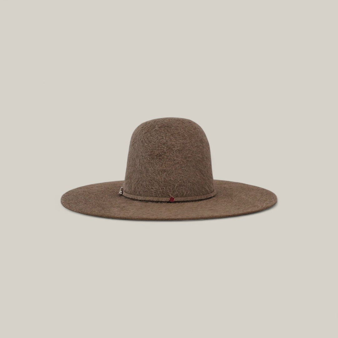 The 10X Grizzly - Tacchino is a wide-brimmed brown felt hat with a rounded open crown and a thin, subtle band—an elegant luxury piece for any collection, shown against a plain light beige background.