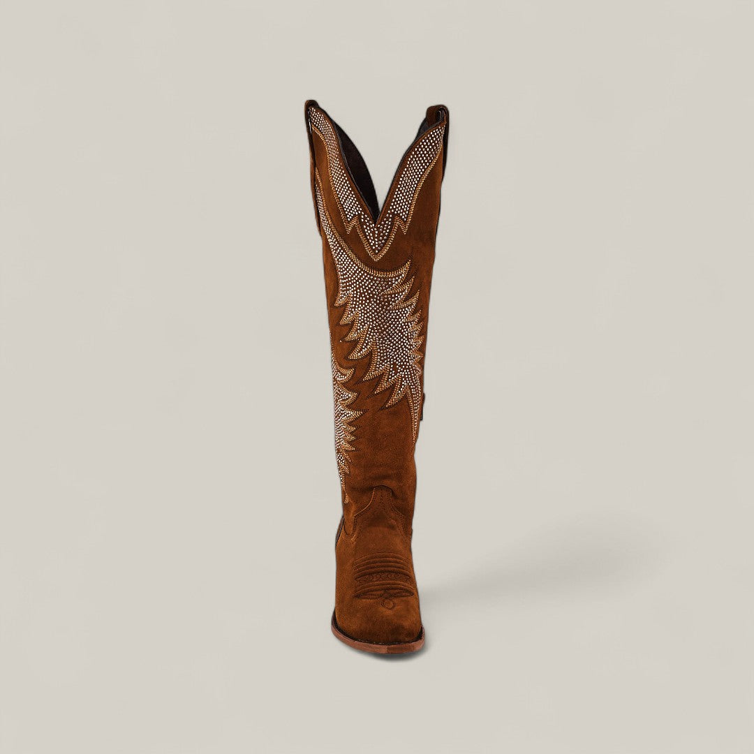 The Daisy Camel - Tall Shaft - Snip Toe features brown suede, white embroidery, and a pointed toe, standing upright against a plain background—an ideal choice to elevate any women’s fashion boot collection.