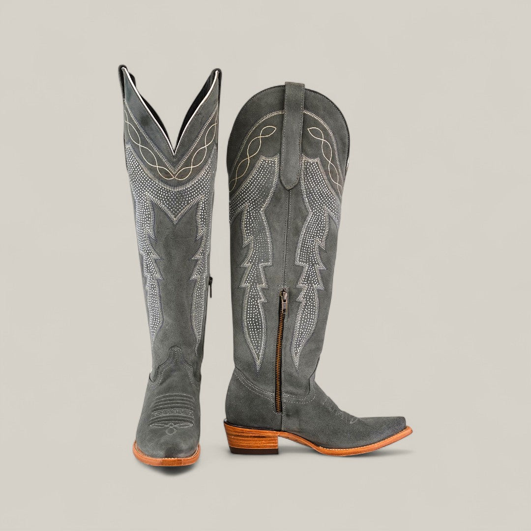 The Celine Gray - Tall Shaft - Snip Toe womens boots feature gray suede, decorative stitching, wooden heels, pointed toes, and a side zipper, shown against a plain beige background.