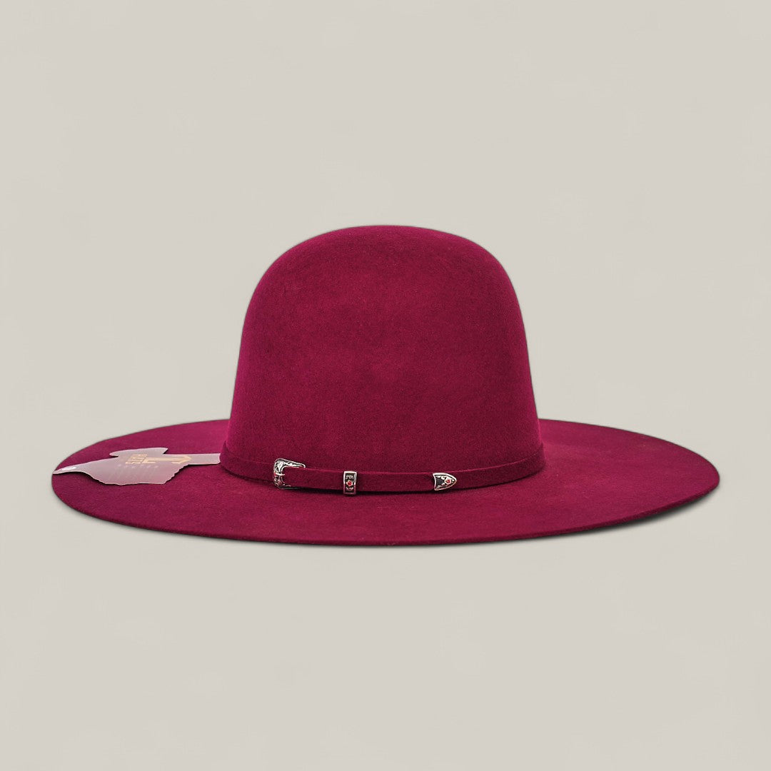 The 4X Burgundy - TC Hats is a wide-brimmed felt Western hat in burgundy with a matching decorative band and silver buckle, shown on a plain light grey background.