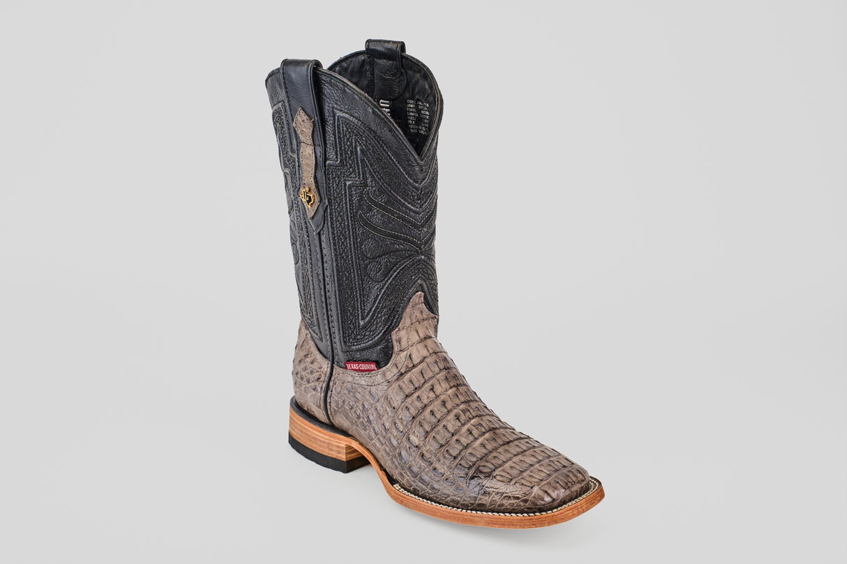 The Exotic Caiman Horn Back - Serpentine - Square Toe boot showcases a textured light brown foot, black stitched upper, square toe, and low wooden heel, set against a plain light gray background.