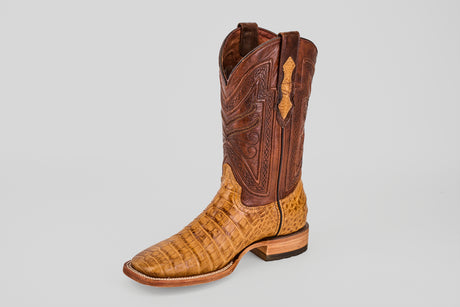 Introducing the Exotic Caiman Belly - Camel - Square Toe: a single cowboy boot with a tan caiman leather lower, brown stitched tall shaft, and classic square toe, displayed on a plain light gray background.
