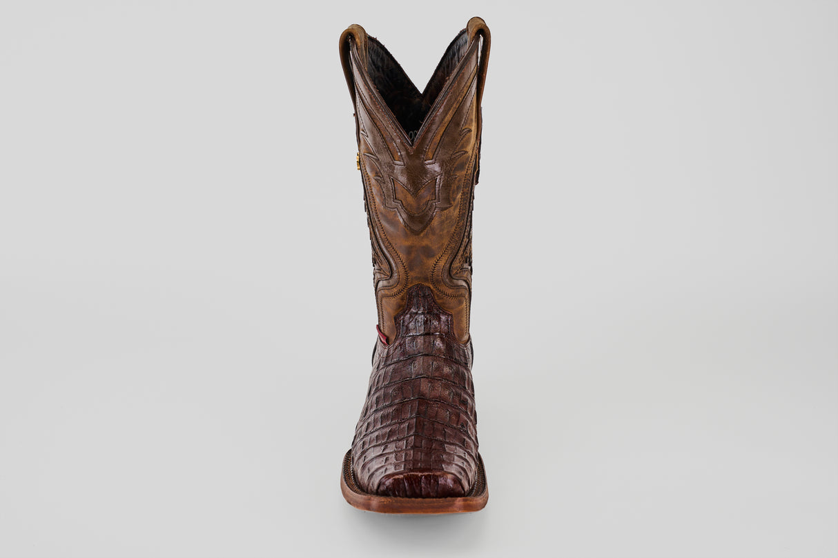 The Exotic Caiman Hornback - Brown - Rodeo Toe is a single cowboy boot made from genuine caiman leather, showcasing a crocodile-like texture and decorative upper stitching, displayed front-facing on a plain light background.