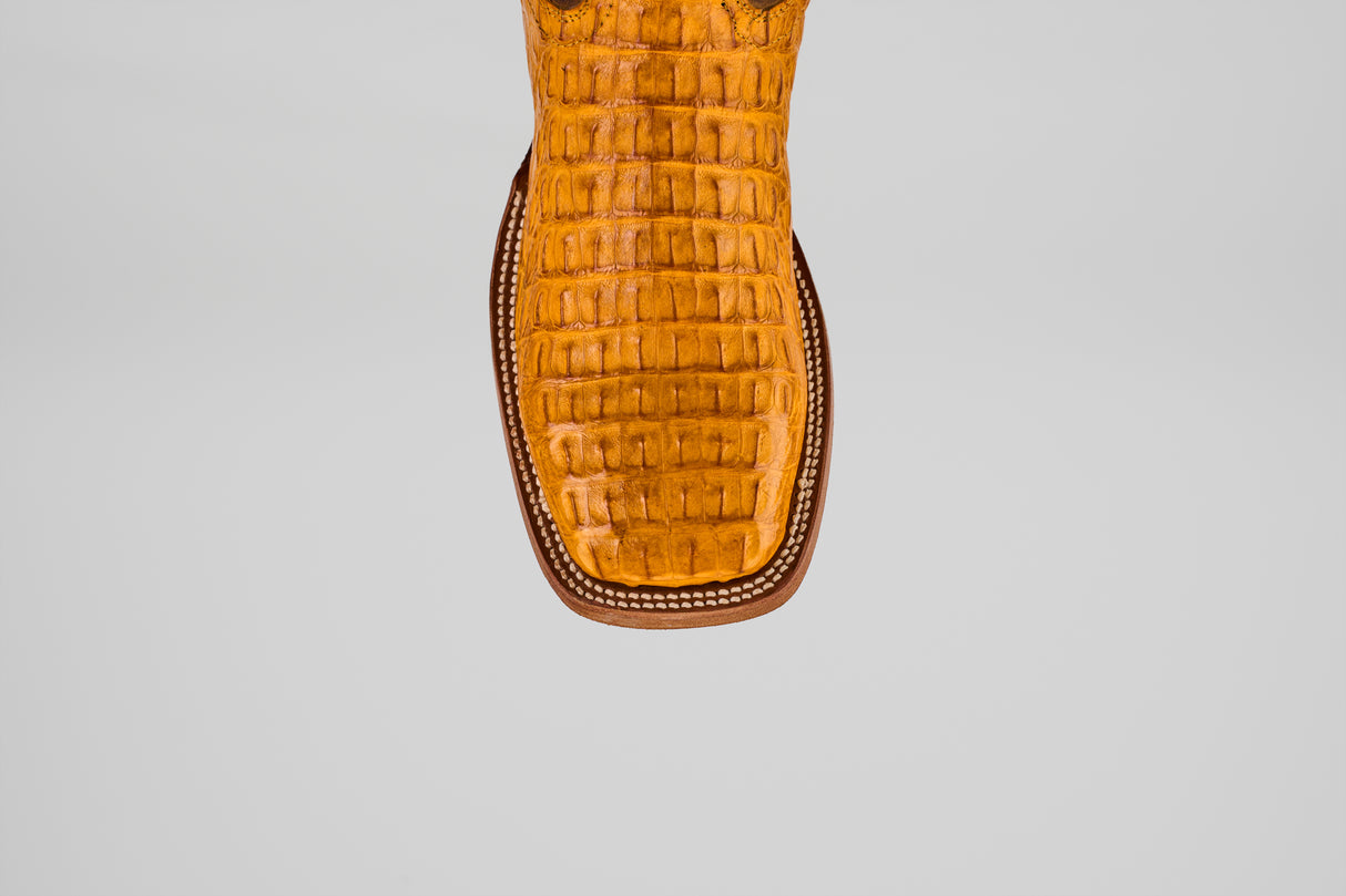 Close-up of the toe of the Exotic Caiman Horn Back - Buttercup- Square Toe boot, featuring a brown, crocodile-like pattern and detailed edge stitching that highlights its classic square toe style.