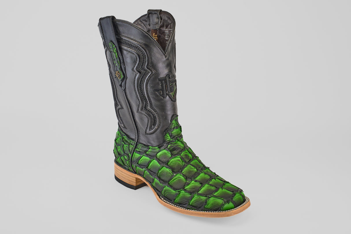 The Conor - Swamp Green - Square Toe boot features a black leather upper, bright green scale-textured lower half, wooden sole, and detailed stitching—ideal for fans of exotic Pirarucu fish boots.