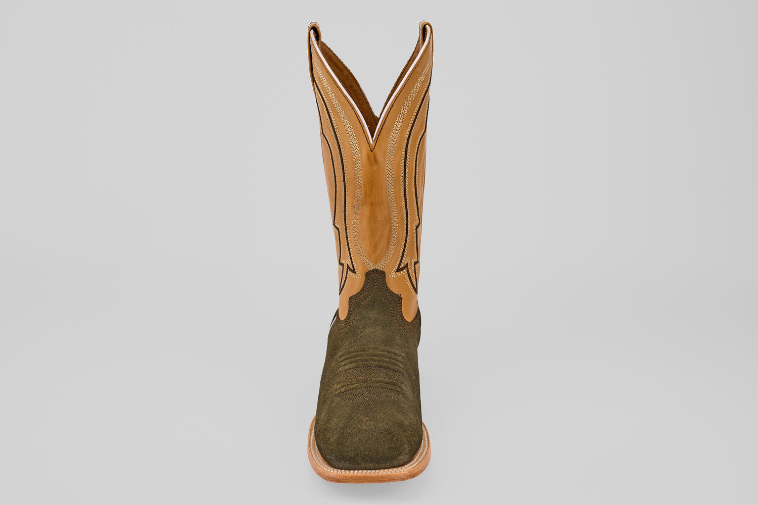 The Prime Suede Green Olive - Square Toe men’s boot features a green olive suede foot, tan leather shaft with decorative stitching, and a square toe, displayed facing forward on a plain light background.