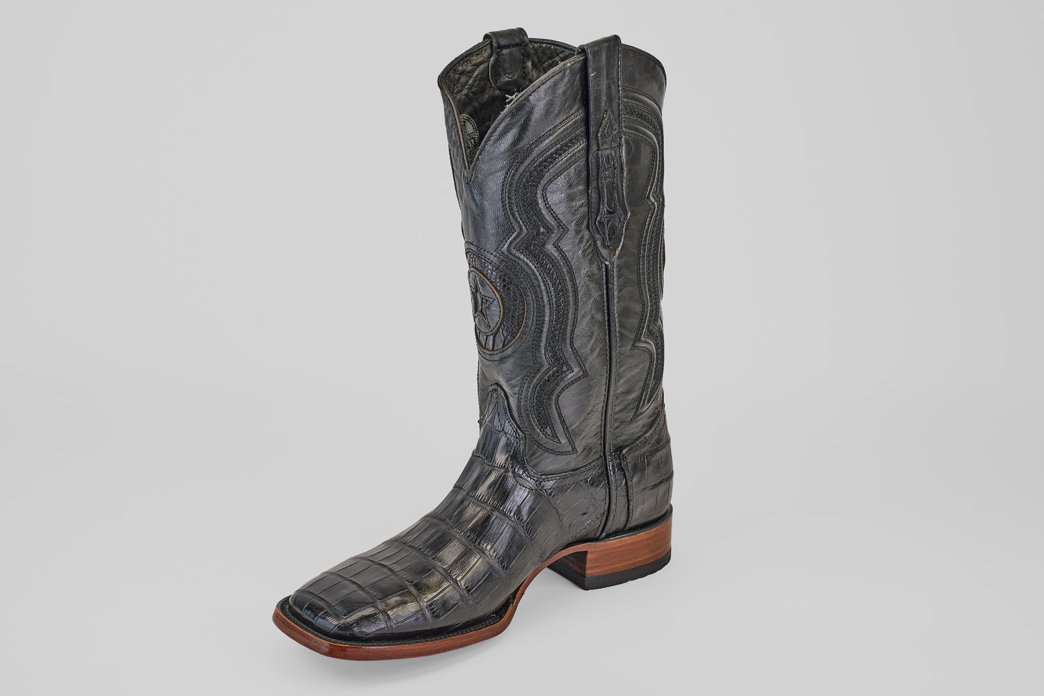 The Exotic Alligator Tail - Black - Square Toe boot features genuine black alligator leather with decorative stitching, a square toe, and a wooden heel, shown on a plain white background.