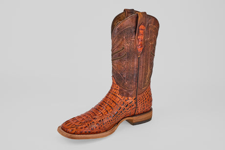 A single Exotic Caiman Head - Cogñac - Square Toe cowboy boot with an intricate leather pattern and textured, crocodile-like finish on the lower part, displayed against a plain light gray background.