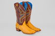 The Ransom - Buttercup - Square Toe boots feature tan ostrich leather on the foot, brown shafts with colorful blue and yellow stitching, and a vibrant blue lining inside.