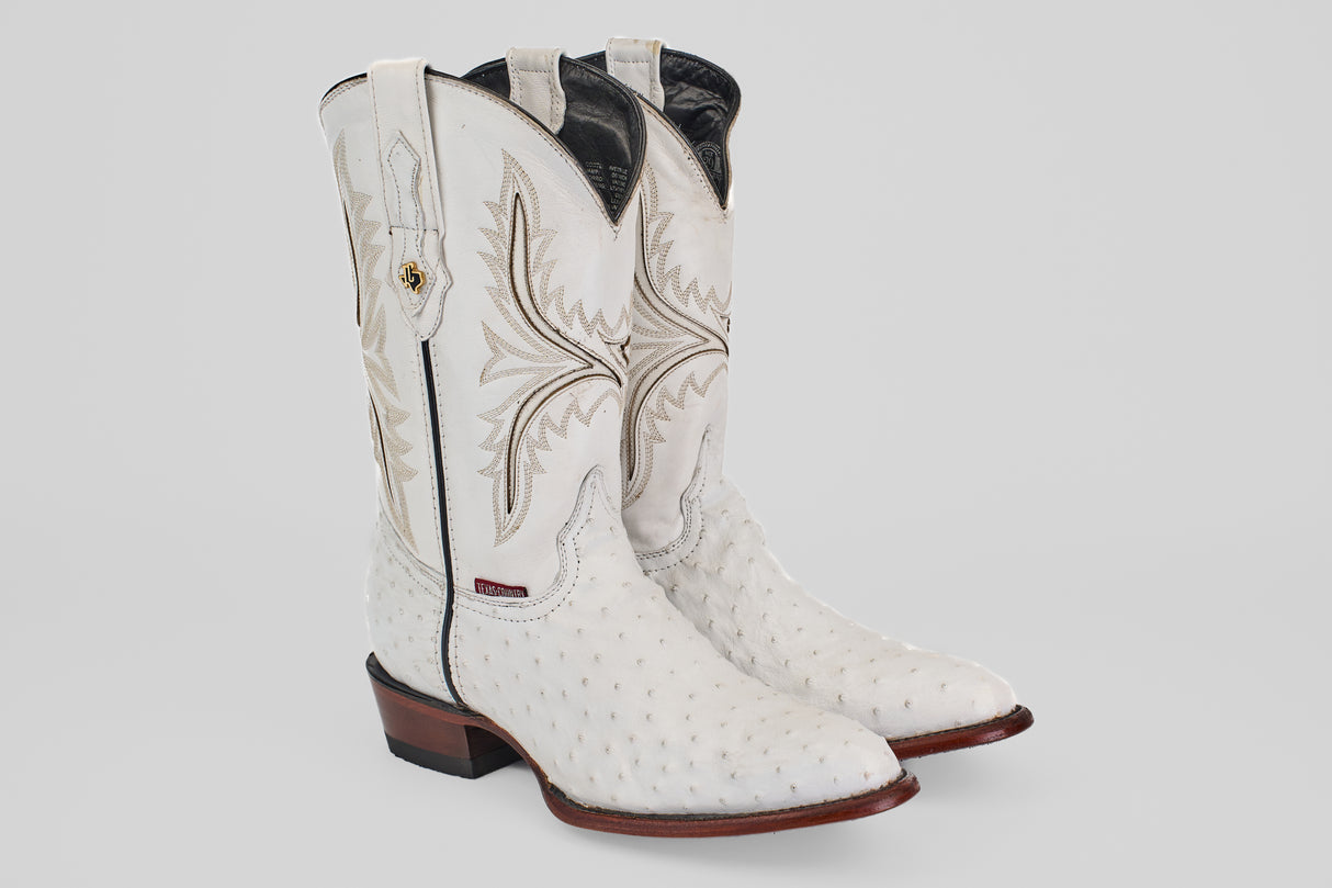 A pair of Austin - White - Round Toe boots, featuring decorative stitching, textured leather, round toes, and brown stacked heels with distinctive oval patterns, displayed on a plain light background.