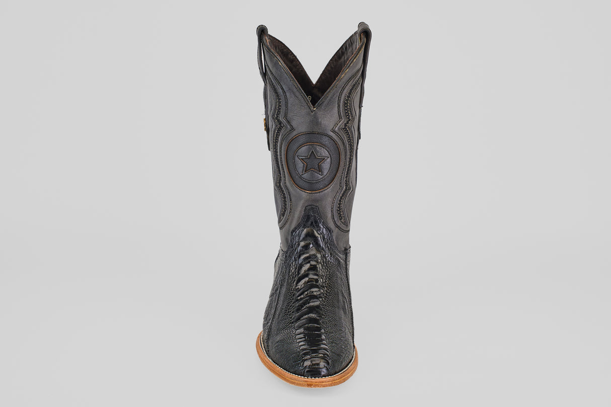The Austin Leg - Black - Roper Toe is a black leather western boot with decorative stitching, a star emblem on the shaft, and a light brown sole, displayed front-facing against a plain white background.