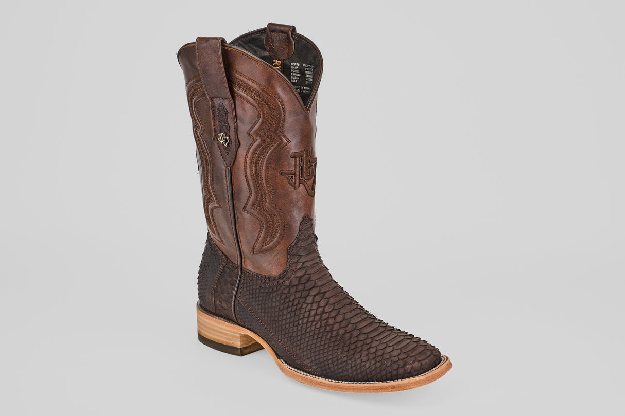 The Tanner - Matte Brown - Square Toe cowboy boot, featuring Python Cafe Nobuck with a textured lower section, decorative stitching on the shaft, and a light wooden heel, is displayed against a plain light gray background.