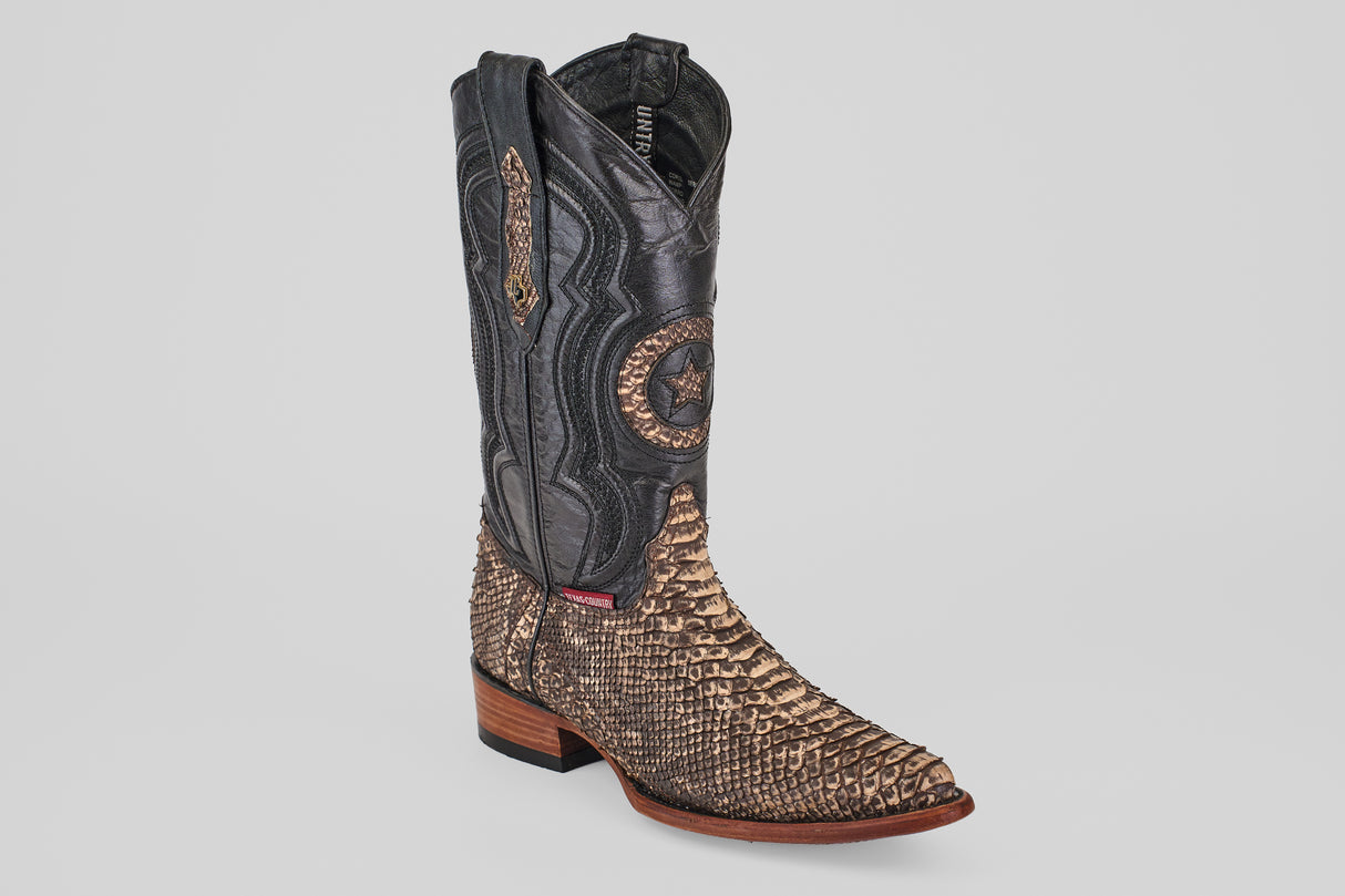The Tanner – Rustic Bone – Snip Toe is a western-inspired boot with a black upper, tan snakeskin-patterned lower section, decorative stitching, wooden sole, and classic snip toe for true cowboy style.