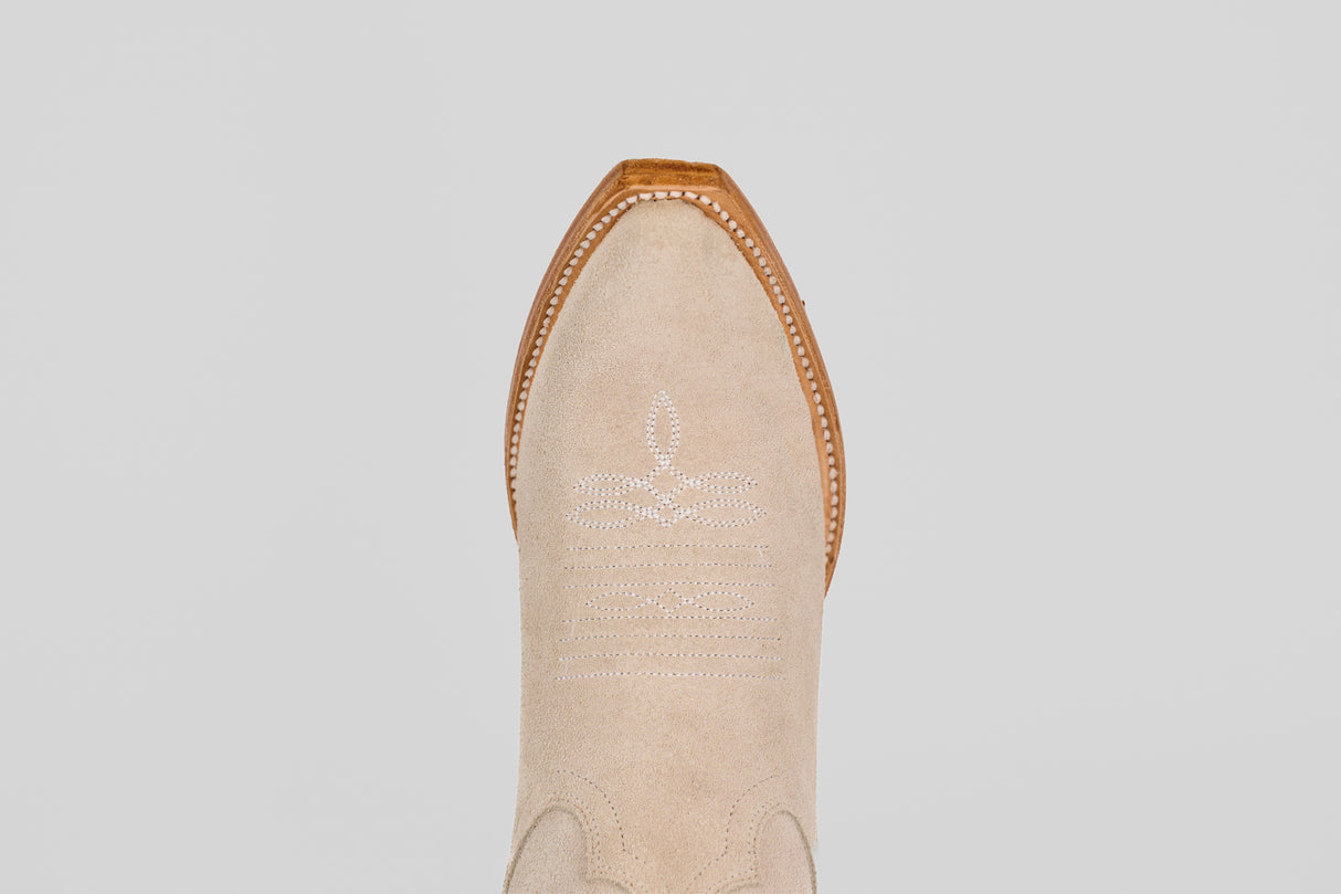 A top-down view of the Allison Ivory - Tall Shaft - Snip Toe boot highlights its ivory color, snip toe, white decorative stitching, and brown leather trim, exemplifying classic women's western boot style.