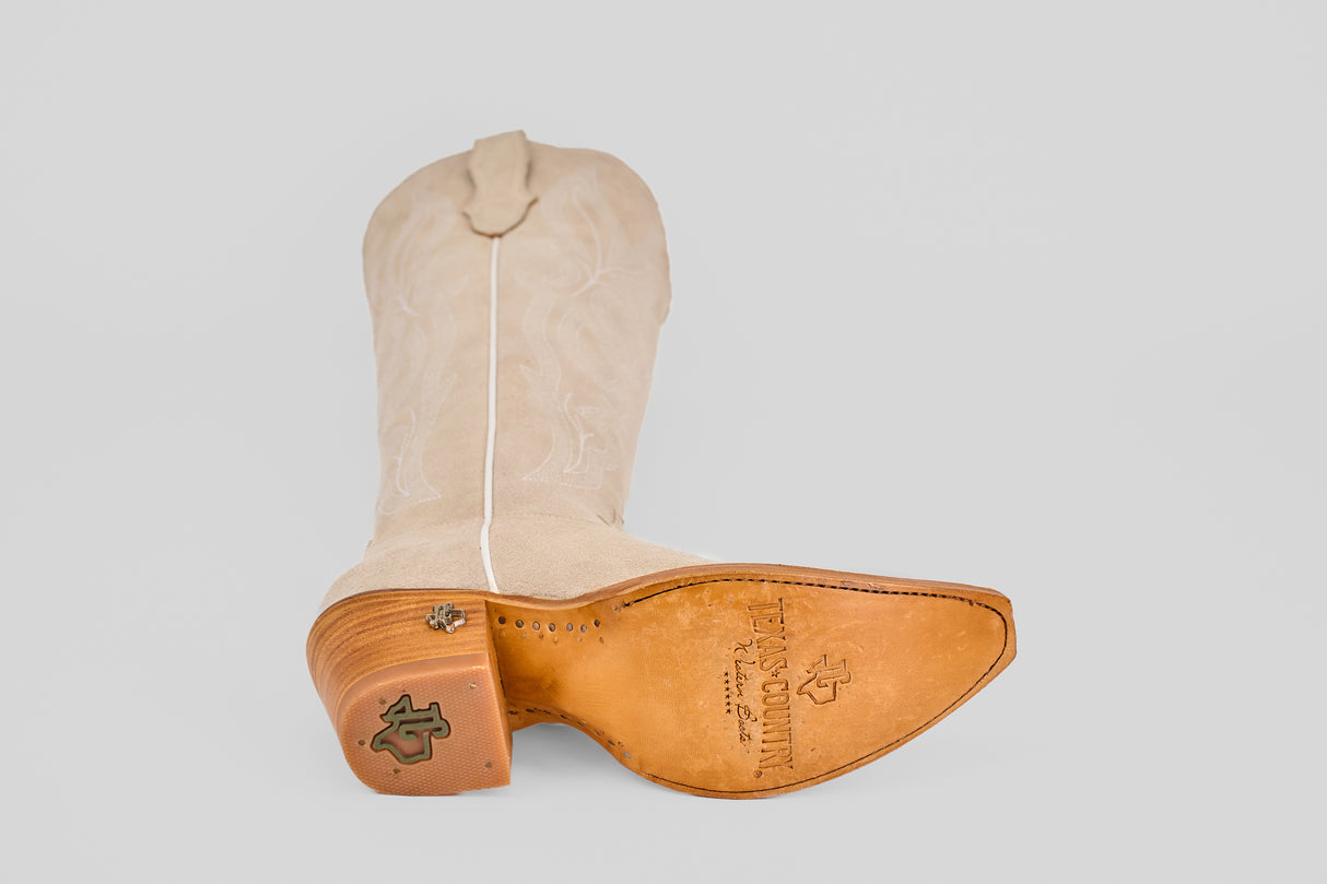 The Allison Ivory - Tall Shaft - Snip Toe boot is shown on its side, featuring a leather sole with logo stamps, snip toe, and detailed stitching along the tall shaft.