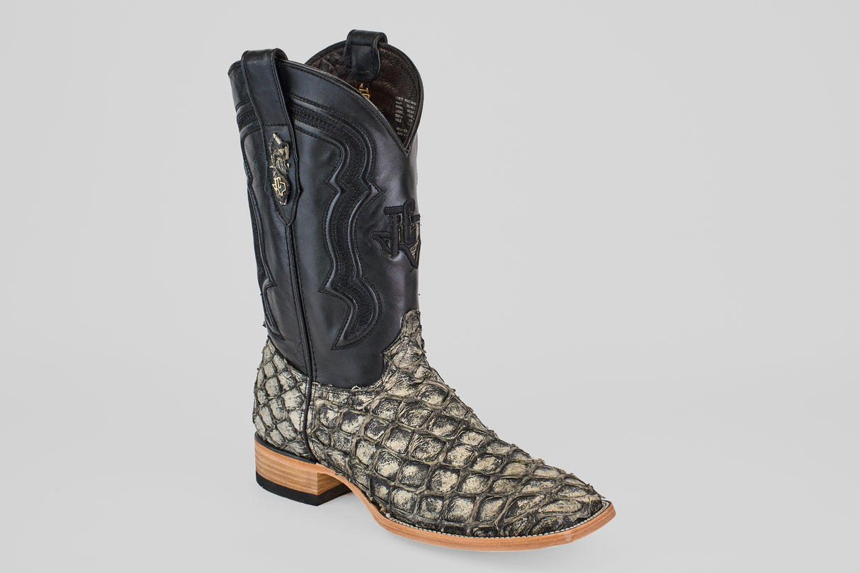 The Conor - Rustic Bone - Square Toe men’s cowboy boot features a black leather upper, a textured rustic bone fish leather lower, a wooden heel, and decorative stitching.