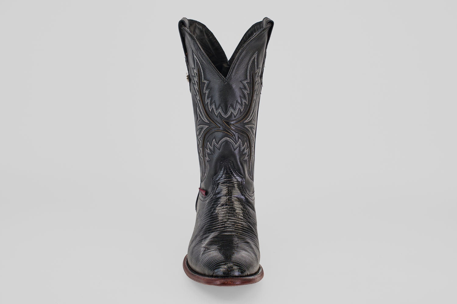 The Blaze – Black – Round Toe boot stands upright against a light gray background, showcasing its decorative stitching, round toe, and gently worn leather texture for a timeless cowboy style.