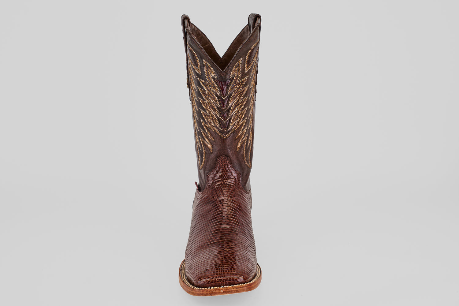 A single Blaze – Brown – Square Toe boot is displayed facing forward on a plain light gray background, highlighting its classic western design and decorative stitching.