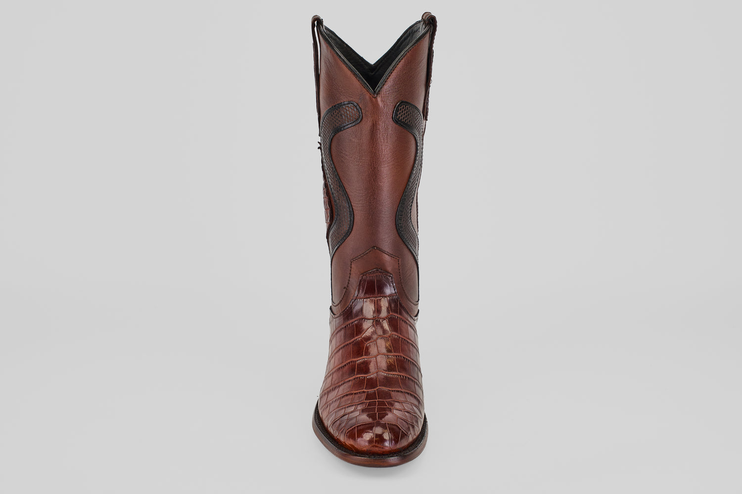The James Platimun - Dark Cogñac boot with a glossy, textured finish and classic roper toe stands upright, facing forward against a plain light gray background.