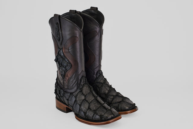 A pair of Conor Platinum - Matte Black - Square Toe (Diamond) boots with a textured, scale-like finish and brown wooden heels, displayed side by side on a light gray background.