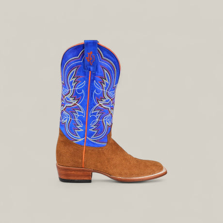 The Bronson - Gold - Square Toe is a men’s boot with a brown suede foot, vibrant blue shaft with colorful stitching, low wooden heel, and standout orange piping for distinctive Western style.