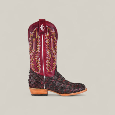 The Maverick - Wild Cherry - Square Toe is a single cowboy boot with a dark textured lower resembling Exotic Pirarucu Fish, a tall maroon shaft featuring yellow and red stitching, and a square toe—all on a plain light background.