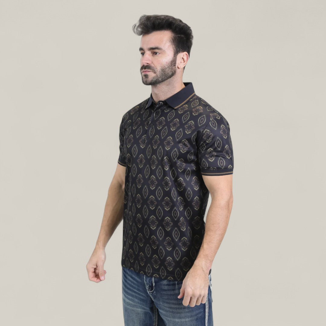 A man with short dark hair and a beard wears the Mens Modern Fit Stretch Cotton Black Polo with Aztec Print (AZP10859) and blue jeans, standing against a plain light background. He faces slightly left, his expression neutral.