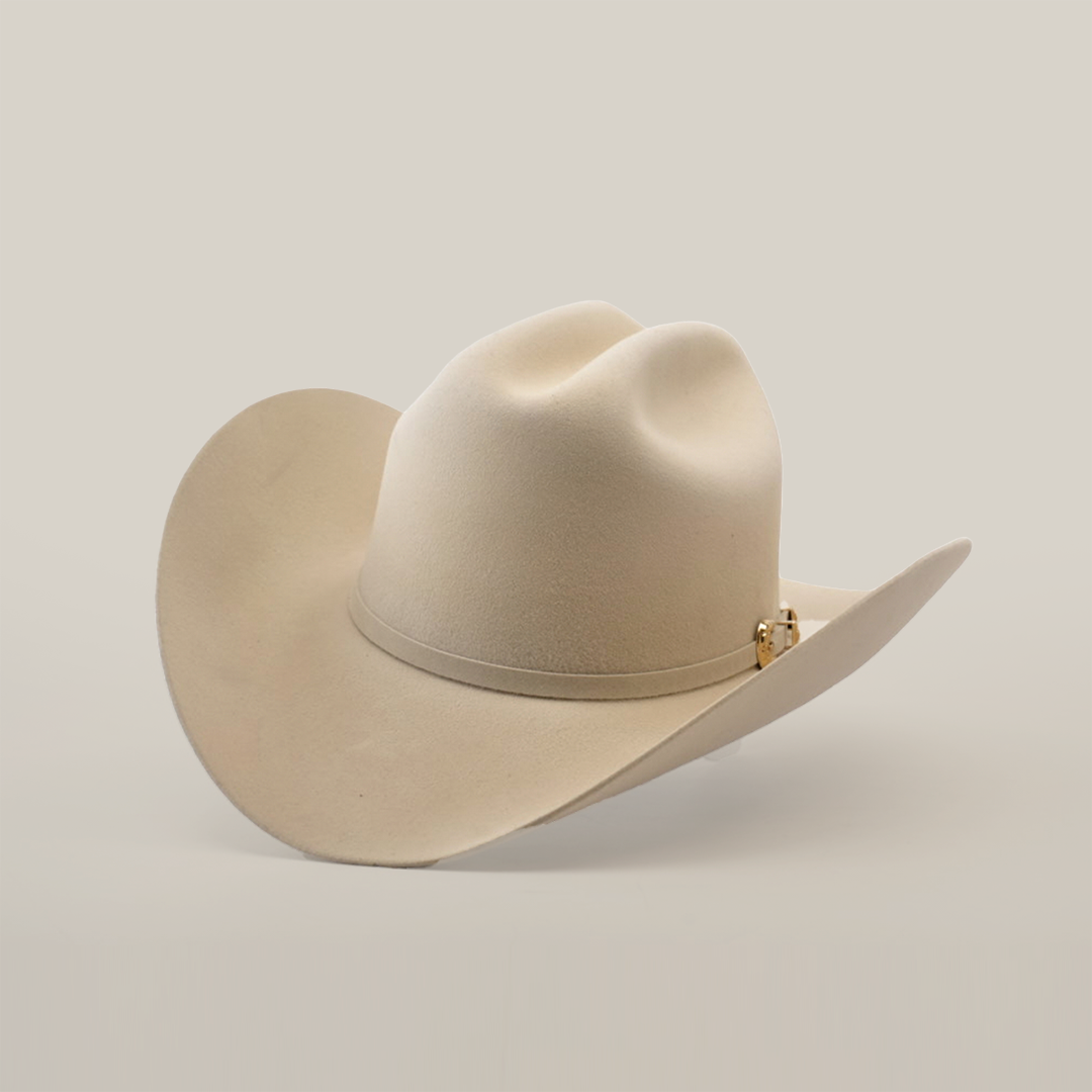 The 5X Dorado Belly, a beige cowboy hat crafted from fur felt with a wide brim and pinched crown, exudes timeless elegance against a plain white background.
