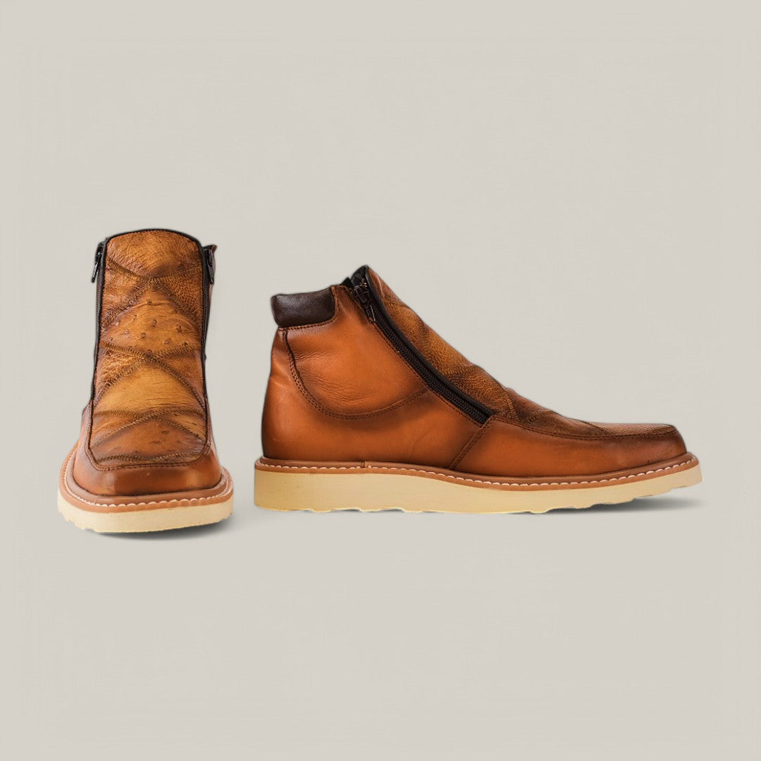 Exotic Ostrich - Fawn ankle boots, crafted from ostrich leather, with side zippers and beige soles, are displayed on a neutral background. One boot is shown from the side and the other from the front, highlighting their unique texture and design.