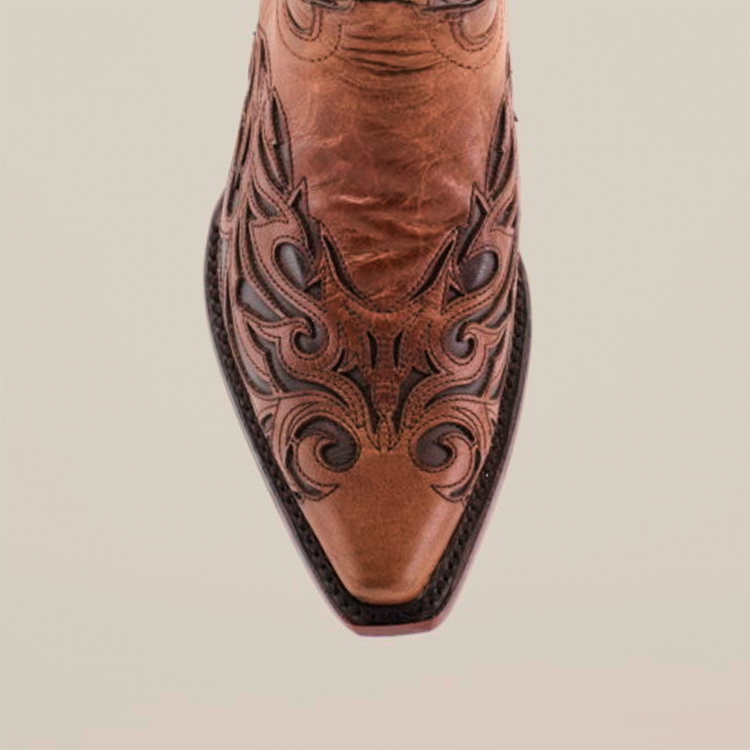 Close-up of the Trivia Orix - Short Shaft - Snip Toe boot, crafted from premium leather with intricate black stitching and decorative toe designs, set against a plain white background.