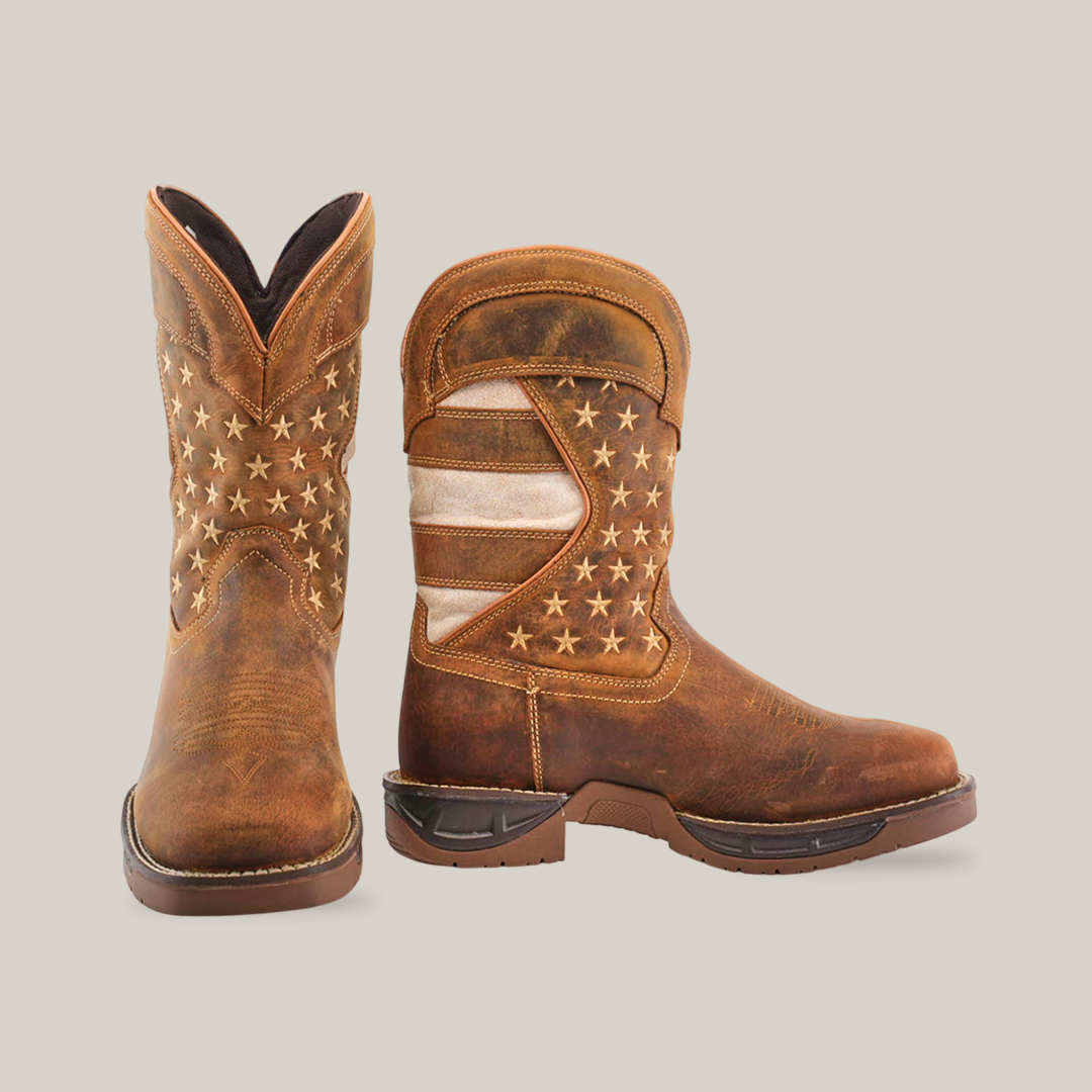 The White Tan US Flag cowboy boots feature a tan brown color crafted from premium cowhide leather with an American flag design. The left boot showcases star patterns, while the right reveals stripes and stars. Theyre handcrafted with rugged excellence and have waterproof black soles.