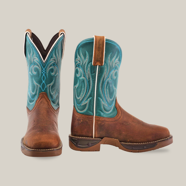 The Rustic Turquoise Brown boots feature premium cowhide leather with brown foot and turquoise embroidered shafts, exuding rustic charm. The left boot is displayed forward, while the right is angled, showing both front and side views.