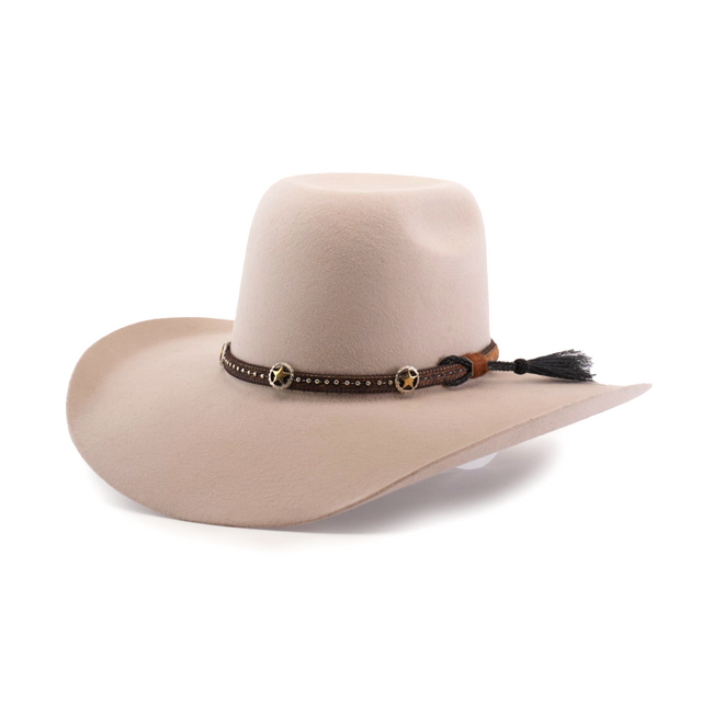 The 6X Brazil Belly is a wide-brimmed beige cowboy hat made from genuine sheep wool, featuring a black premium leather band with small stars and a brown tassel. It has a rounded crown and slightly curved brim edges.