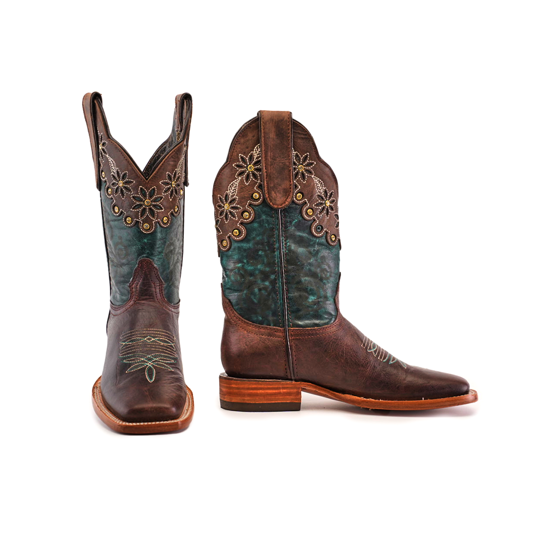 A pair of Grecas Brown - Short Shaft - Square Toe boots features teal accents and floral embroidery on the shaft. One boot is angled forward, the other side-on, highlighting the wooden heel and intricate stitching, showcasing luxury western footwear at its finest.