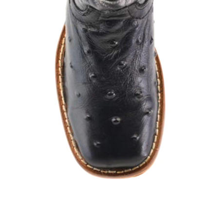 Close-up top view of the Karoo Ostrich Print Black Square Toe cowboy boot in premium cowhide leather, featuring unique textured patterns. The boot boasts a square toe, brown sole with white stitching, and an embossed design on the upper part.