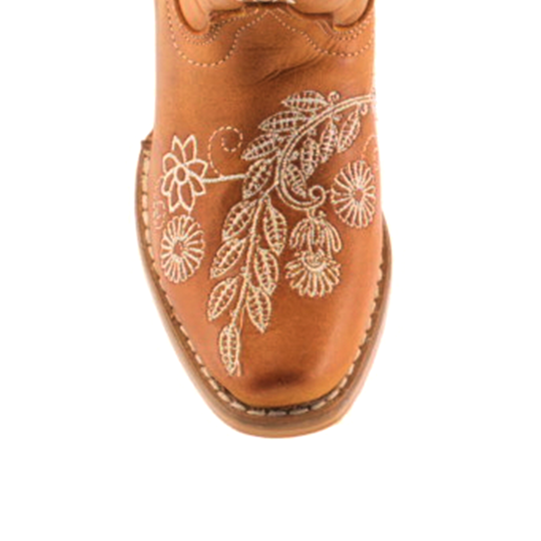 The Rama Honey - Snip Toe boots feature genuine leather in a brown cowboy style for young girls. White floral embroidery enhances the toe, complemented by stitched leaf and flower patterns for a classic textured design.