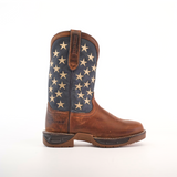 A brown cowboy boot made from premium cowhide leather has a dark blue shaft with white stars. The Navy Brown US Flag - Waterproof - Soft Toe offers a sturdy sole, intricate stitching, and features the brands embossed name. The background is plain white.