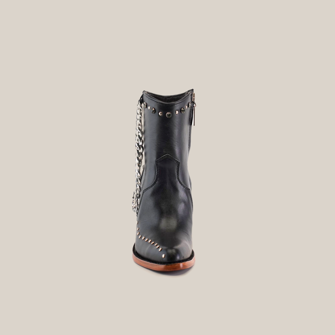 Front view of the Milan Chains Bootie Black - J Toe, a luxury ankle boot with premium leather, silver studs, and chain embellishments. It boasts a pointed toe and brown sole, highlighting its edgy style.