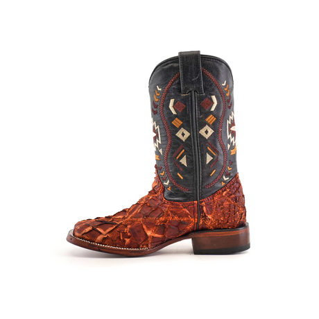 The Exotic Pirarucu Fish Patchwork Cogñac Square Toe boot features exotic Pirarucu fish leather that resembles reptile skin on the lower part and vibrant geometric patterns against a black background on the upper part. It is finished with a wooden heel, fusing rustic charm with exceptional design.