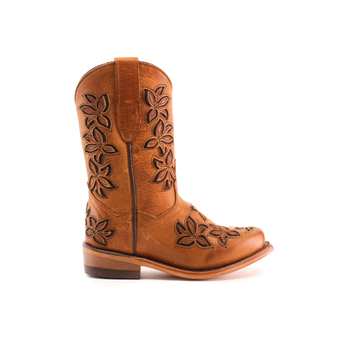 The Cosala Honey - Snip Toe is a brown cowboy boot crafted from genuine leather, featuring floral patterns on the shaft and toe. It has a low wooden heel, rounded snip toe, and intricate stitching details for the classic western look.