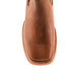 Top view of an Avejentado Honey square toe ankle boot in rich brown leather with intricate stitching framing the toe and edges. Set against a white background, this boot embodies classic cowboy charm and style.