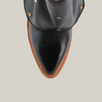 Top view of the Roma Rainbow Crystals Tall Shaft Black - J Toe boot with a pointed toe and tan sole, adorned with small colorful studs, set against a plain white background.