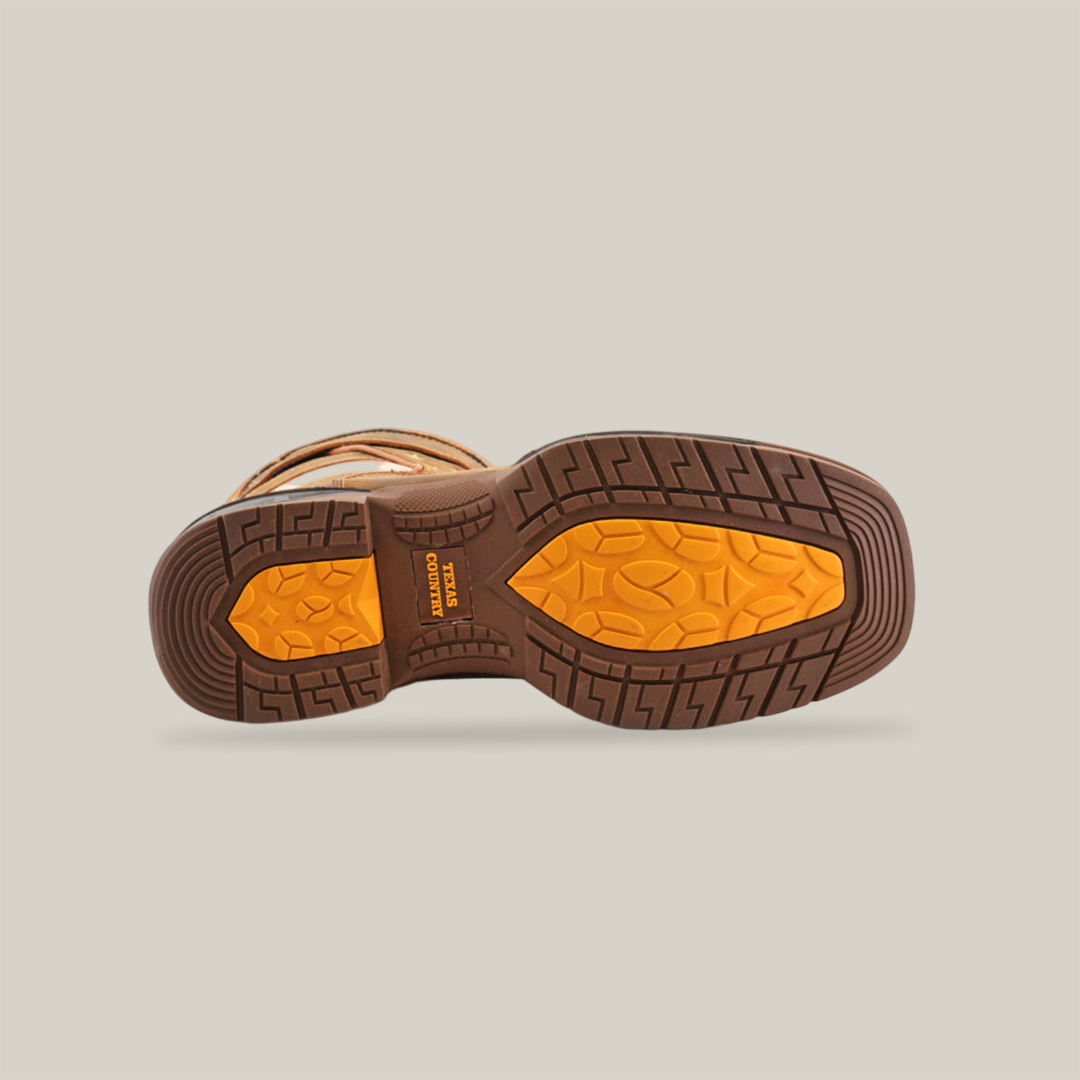 Bottom view of the White Tan US Flag boot, showcasing a textured rugged sole in yellow and brown. Made from premium cowhide leather for traction and durability, these waterproof boots feature a handcrafted excellence on a white background.